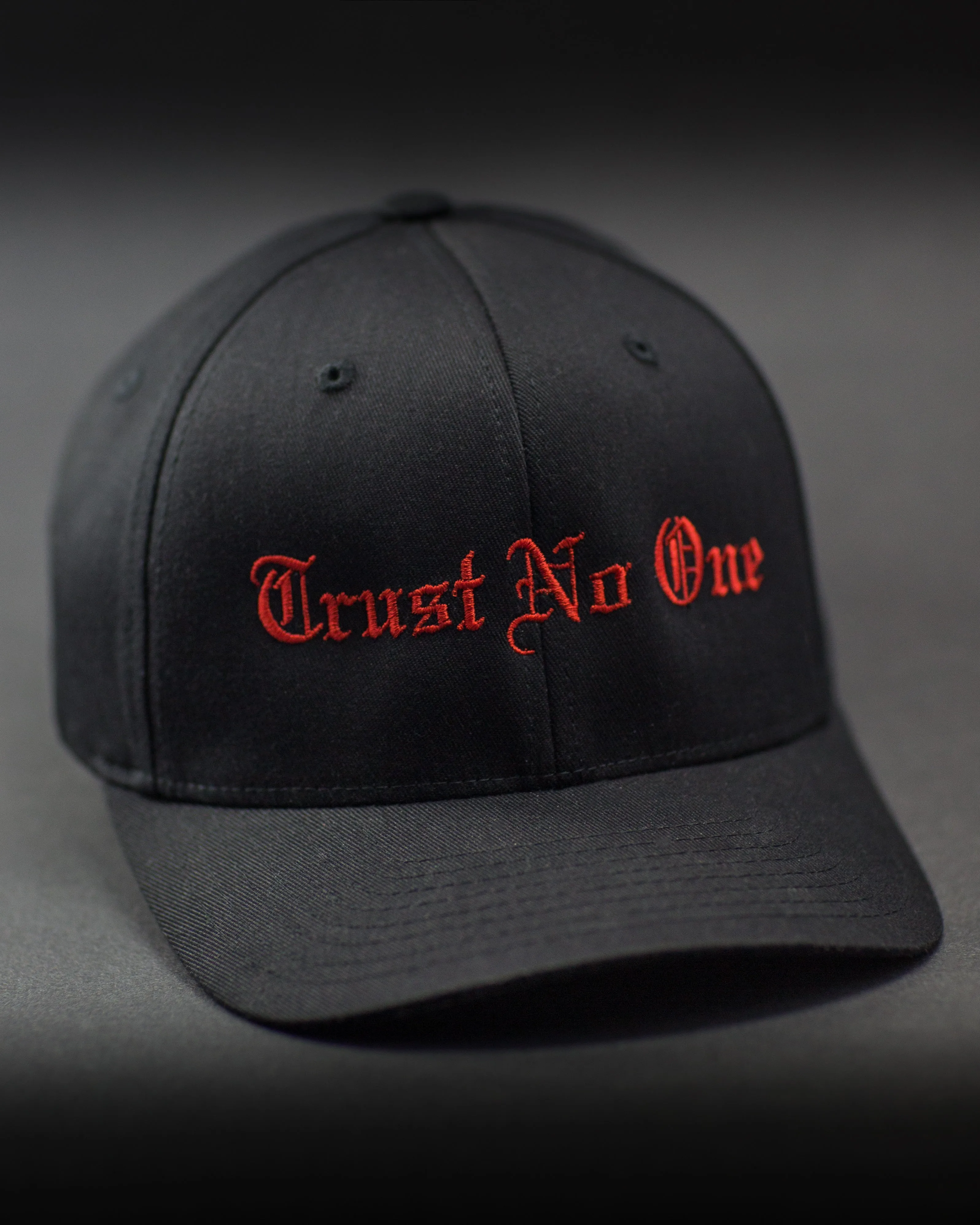 Trust No One Structured Curved Bill Flexfit Hat - Black with Red Stitching